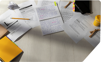  A  workspace with handwritten assignments and highlighters, representing Scora’s ready-to-submit HD assignment writing support.